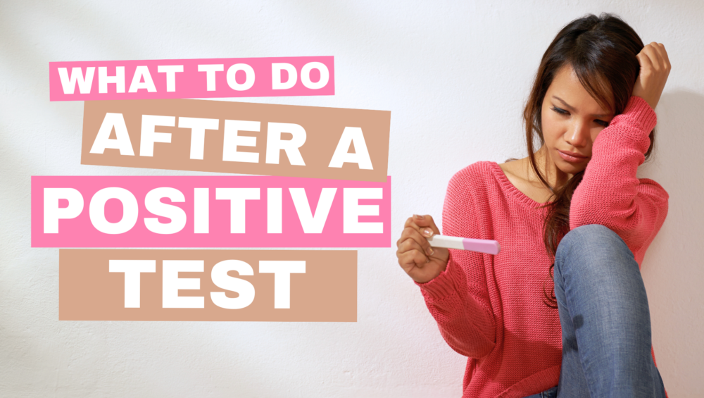 Young woman looking at a positive pregnancy test with concern. She's unsure of what to do after a positive pregnancy test.