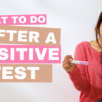 Young woman looking at a positive pregnancy test with concern. She's unsure of what to do after a positive pregnancy test.