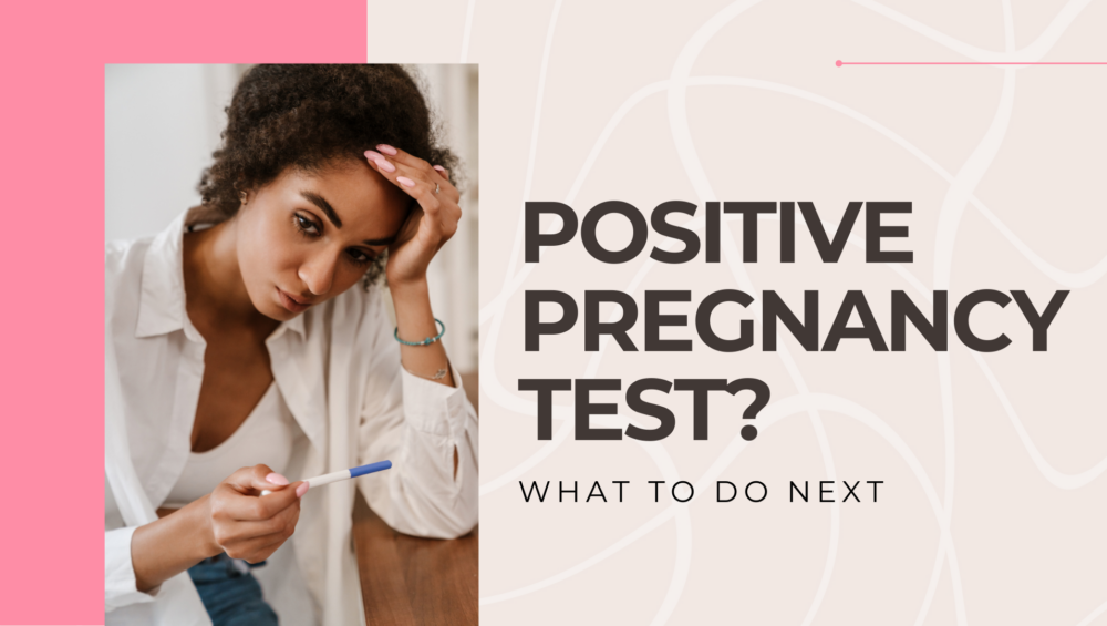 A young black woman looking at her positive pregnancy test, unsure of the next steps.