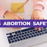 Young woman typing on a laptop with text overlay asking 'Is Abortion Safe?'