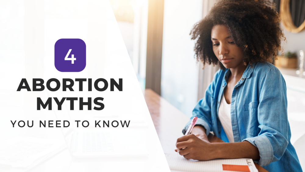 A woman in a blue shirt writes in a notebook while seated at a desk, with the text "4 Abortion Myths You Need to Know" overlayed on the graphic.